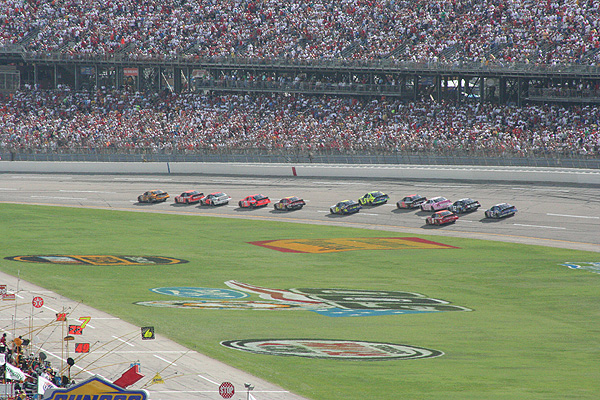 NASCAR stock cars racing on an oval track